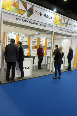 Visitors at the Top Rack Technology booth discussing solar racking systems — Intersolar Mexico 2025