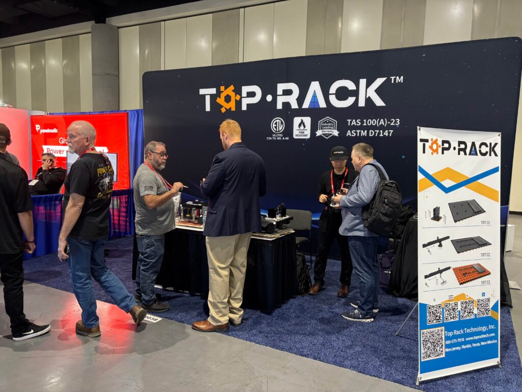 Top Rack Technology at IESNA exhibition booth showcasing residential rooftop solar mounting solutions, with team members engaging visitors and presenting product displays.